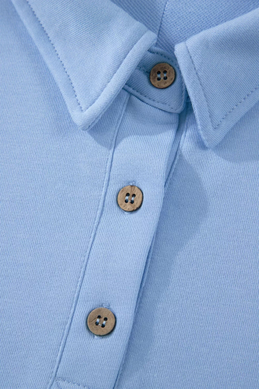 Light blue sleeveless polo shirt with wooden buttons and collar detail
