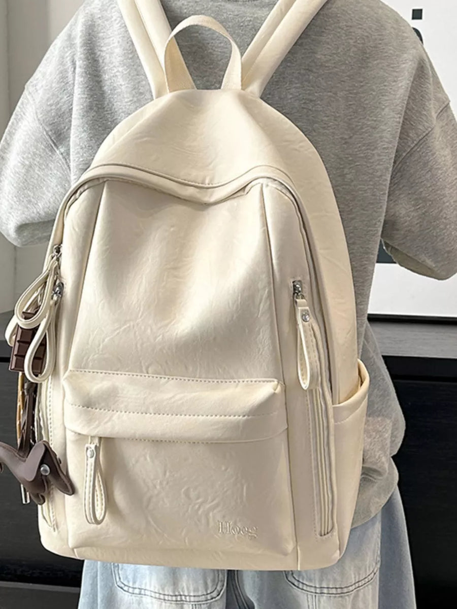 Chic white pu leather medium backpack with front pockets and zipper details.