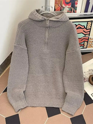 Gray knit hoodie with half-zip neckline and ribbed details.