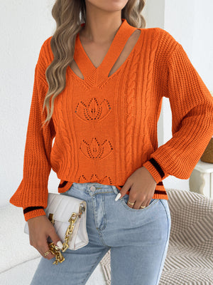 Orange pullover sweater featuring cutout and cable knit