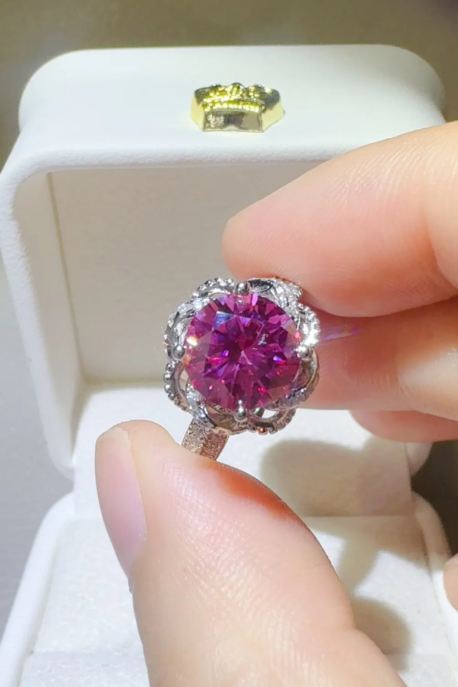 Crimson Bloom moissanite halo ring in cerise with intricate silver detailing.