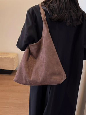 Women's casual suede shoulder bag in brown with a slouchy silhouette and single strap.