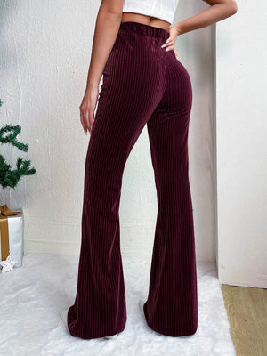 Burgundy corduroy maternity flare pants with high waist and bell bottoms.