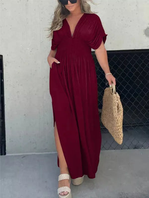 Burgundy V-neck maxi dress with dolman sleeves, smocked waist, and side slits.