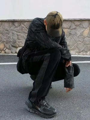 Black velour wide-leg sweatpants with a grey stripe detail on the side.