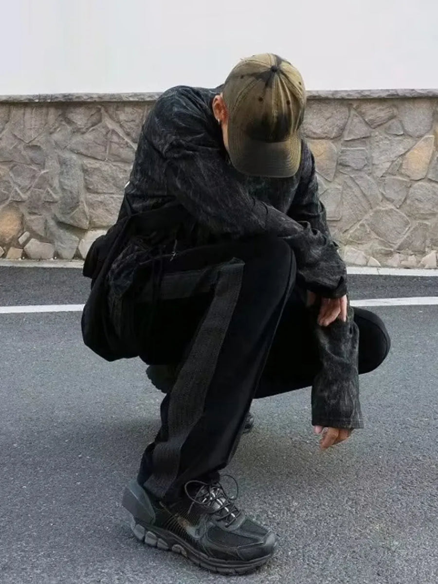 Black velour wide-leg sweatpants with a grey stripe detail on the side.