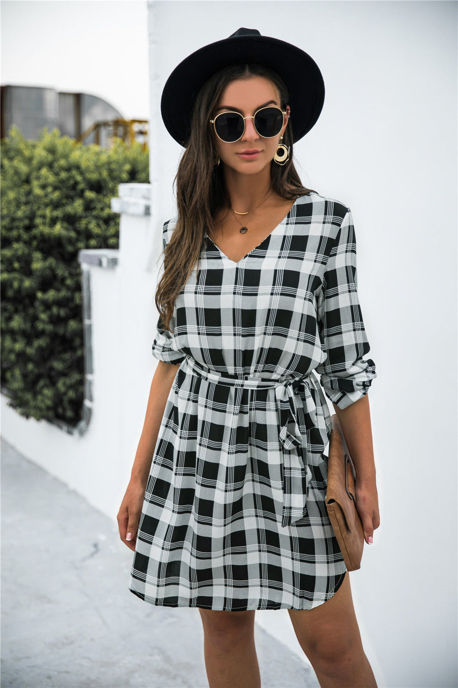 Black plaid shirtdress with V-neck, 3/4 sleeves, and belted waist.