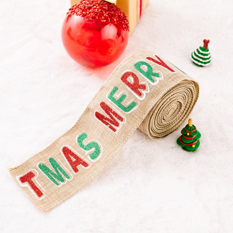 Burlap ribbon with red and green glitter "Merry Christmas" text, rolled up.