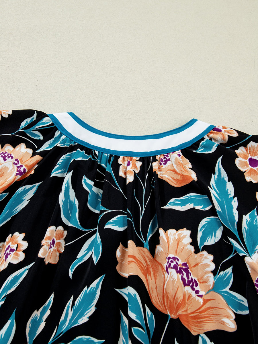 Black floral print blouse with bubble sleeves and a contrast collar.