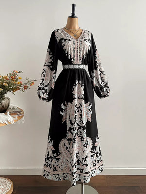 Black maxi dress with V-neck, balloon sleeves, and ornate paisley print.
