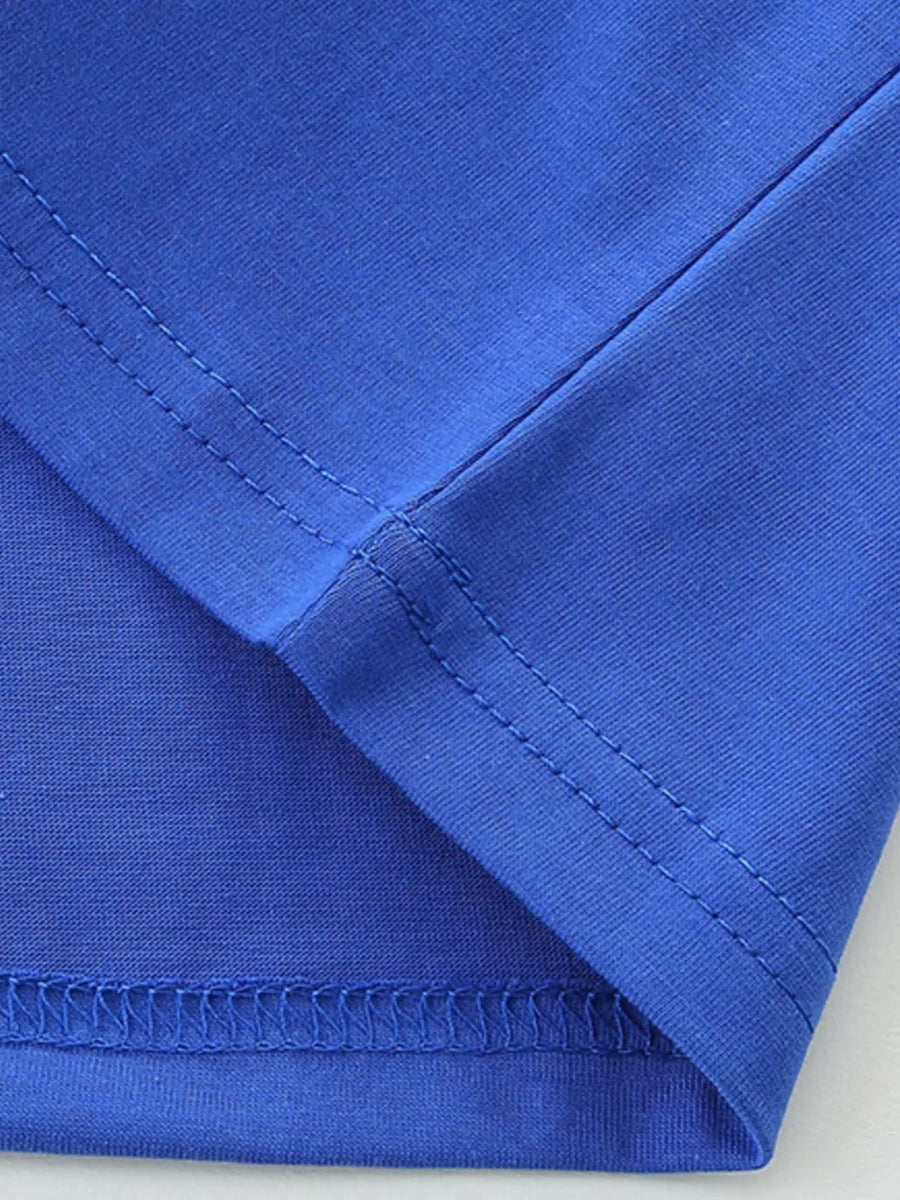 Blue cotton t-shirt detail showing seams and hem.
