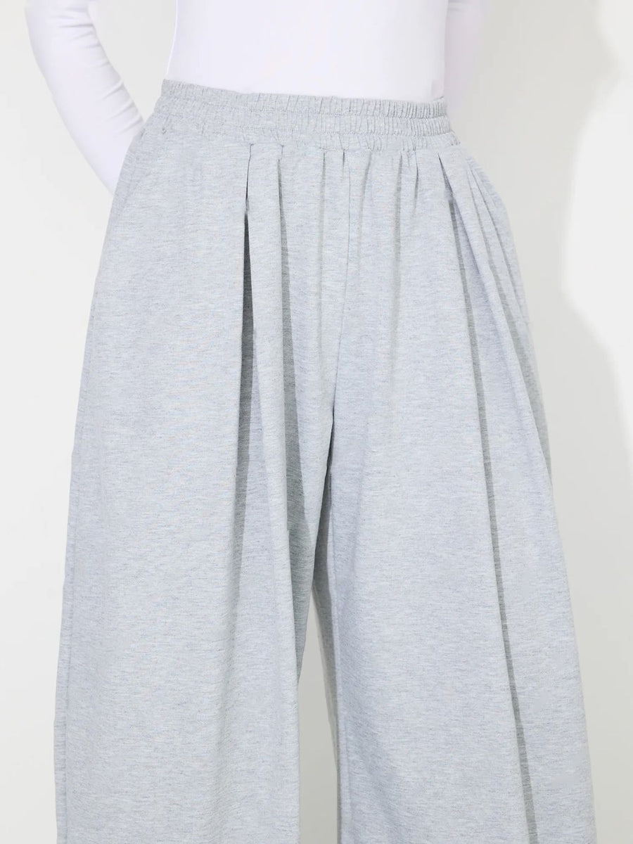 Light gray pleated drape palazzo trousers with elastic waistband and wide leg.