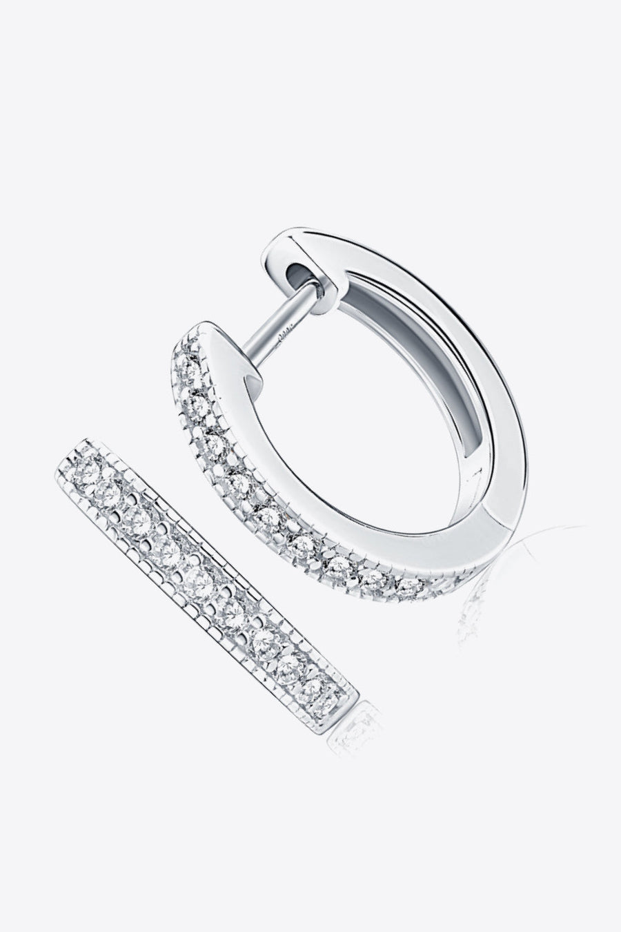 Silver pave-set huggie hoop earrings with sparkling stones.