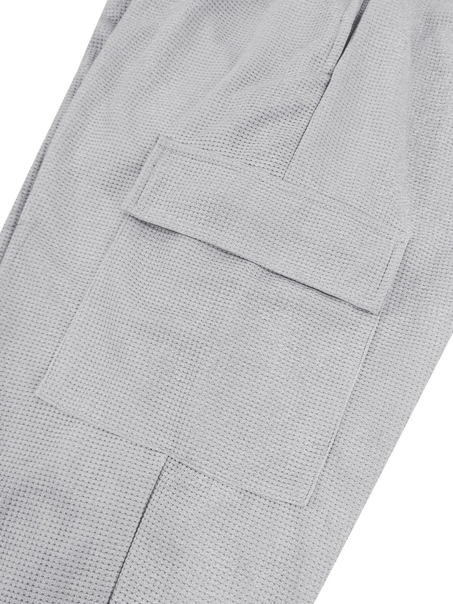 Light gray waffle knit joggers with a flap pocket detail.