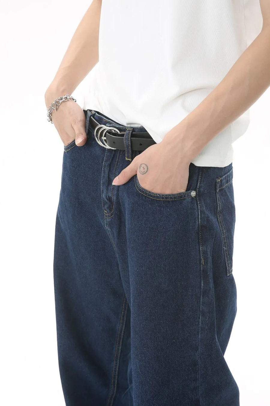 Baggy dark wash denim jeans with a subtle flare, styled with a white t-shirt and black belt.