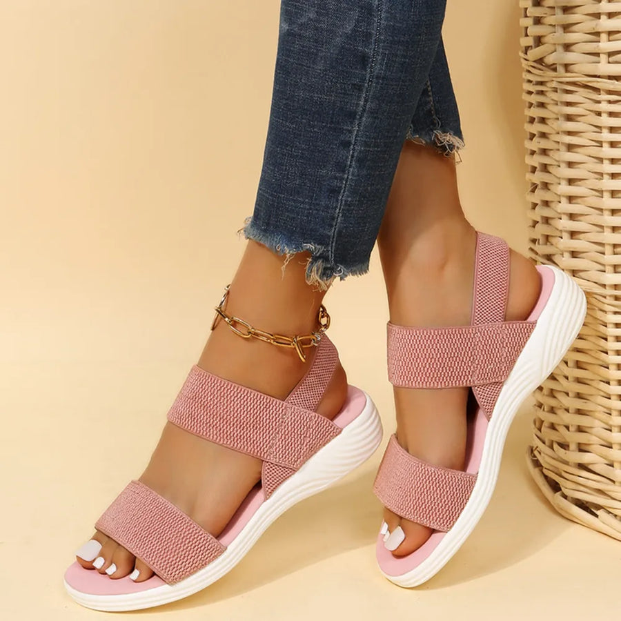 Dusty Pink knit strap sandals with white soles and a gold ankle bracelet.
