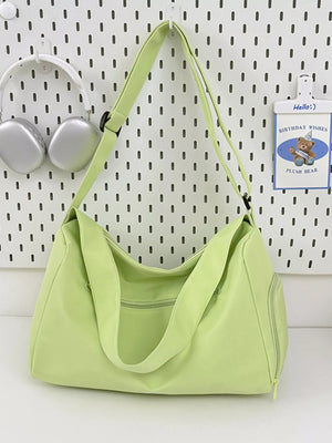 Light green travel pouch with adjustable strap and zippered pockets, perfect for casual use.
