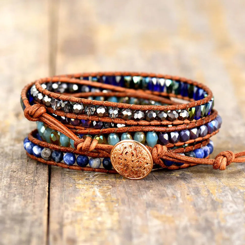 Lapis Lazuli wrap bracelet with brown leather cord and ornate button closure.