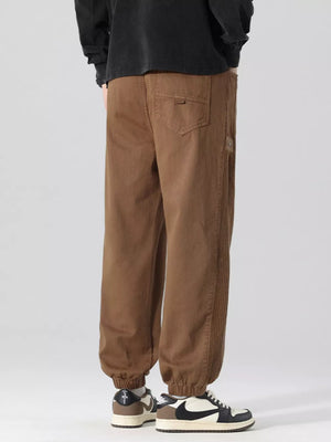 Oversized coffee cargo joggers with drawstring and ribbed side detail.