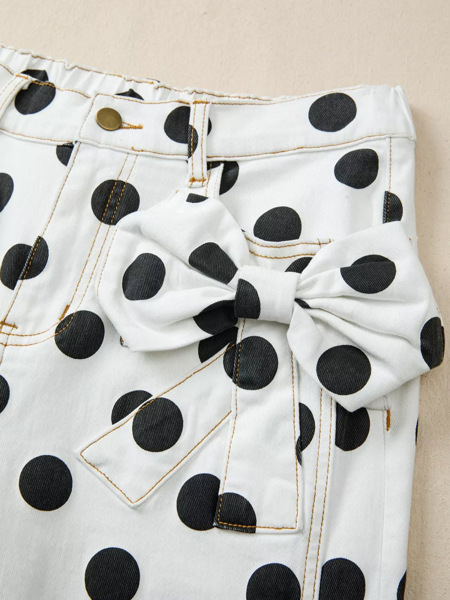 White polka dot denim jeans with large bow detail on pocket