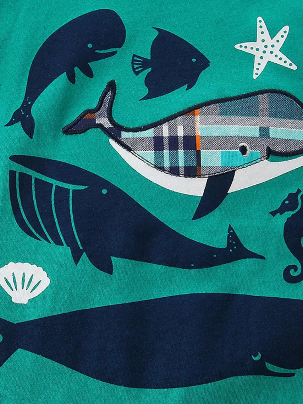 Toddler tee with navy whale and plaid whale print on teal cotton.