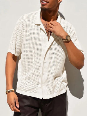 Ivory perforated knit resort shirt with short sleeves and button front.