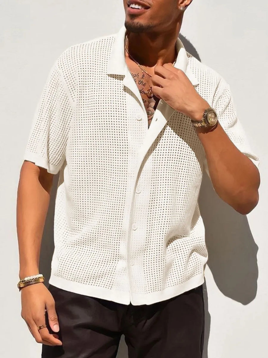 Ivory perforated knit resort shirt with short sleeves and button front.