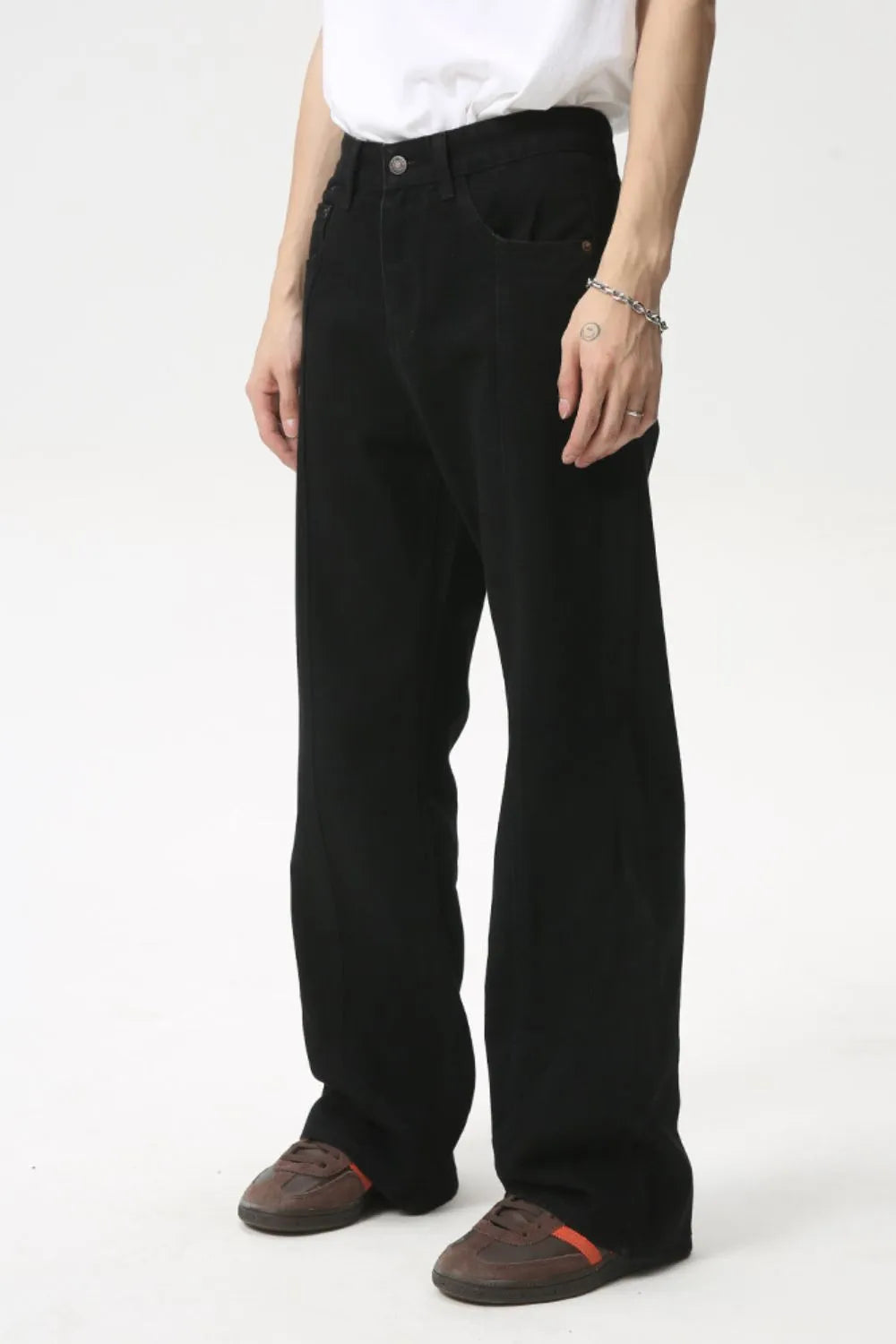 Black denim jeans with panel seams and a flare leg cut.