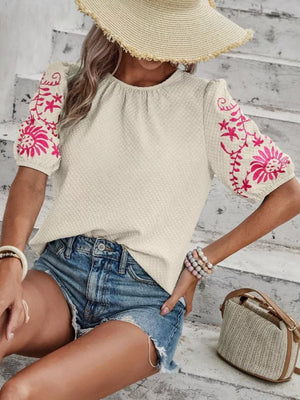 Cream embroidered puff sleeve blouse with pink floral detail on sleeves