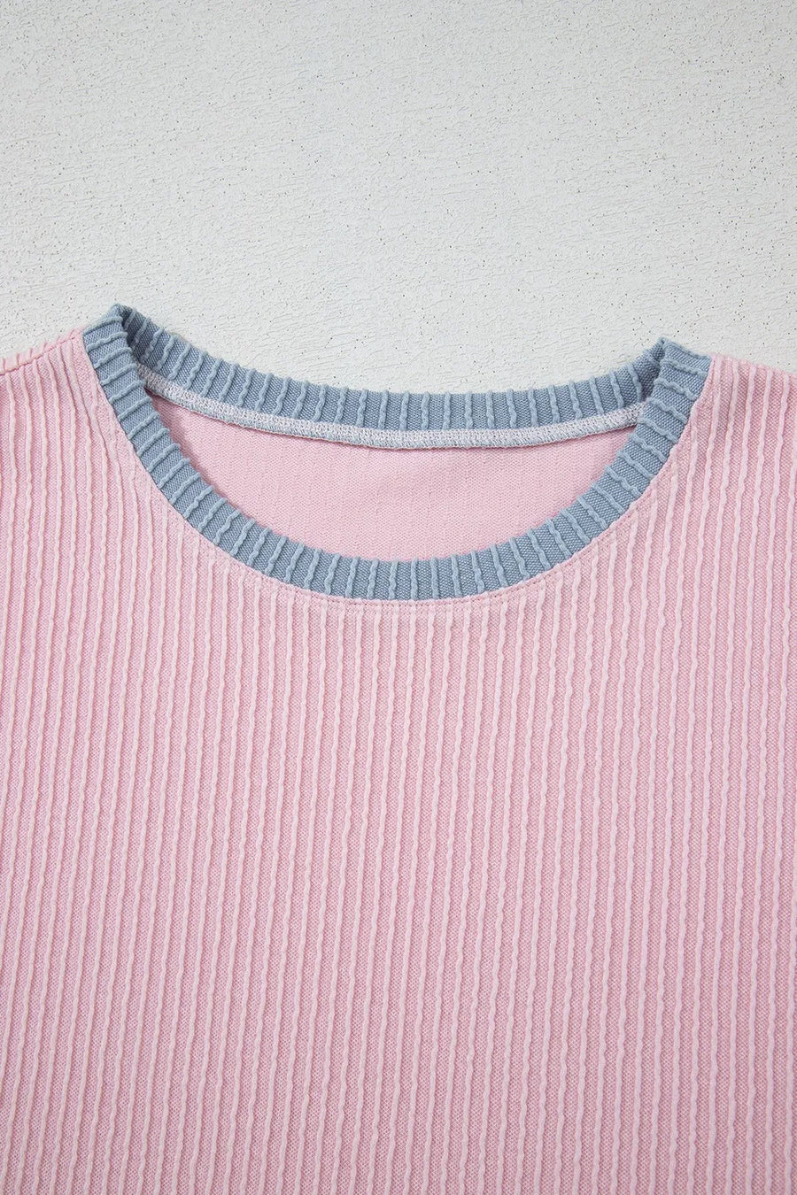 Ribbed blush pink loungewear top with a contrasting grey crewneck collar.