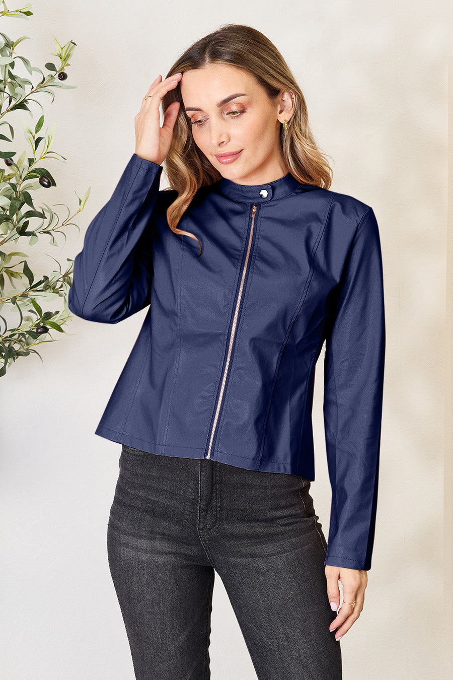 Navy faux leather biker jacket with rose gold zipper and mock neck.