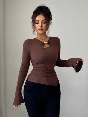 Brown long-sleeve top with asymmetrical cutout and gold detail.