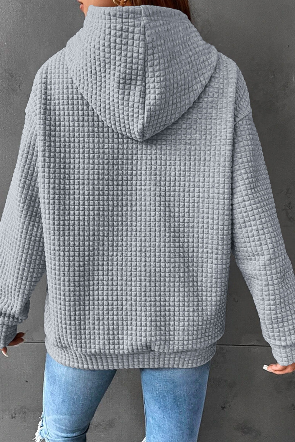 Charcoal waffle knit hoodie with a textured pattern, hood, and long sleeves.