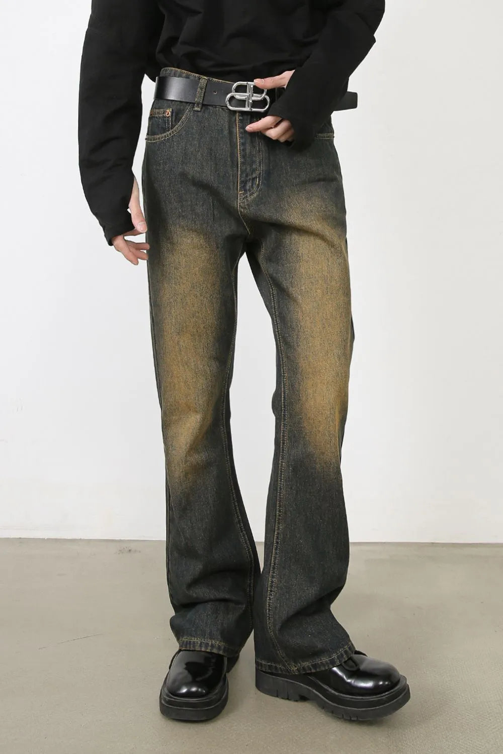 Faded wash bootcut jeans in olive brown with dip dye effect and a relaxed fit.