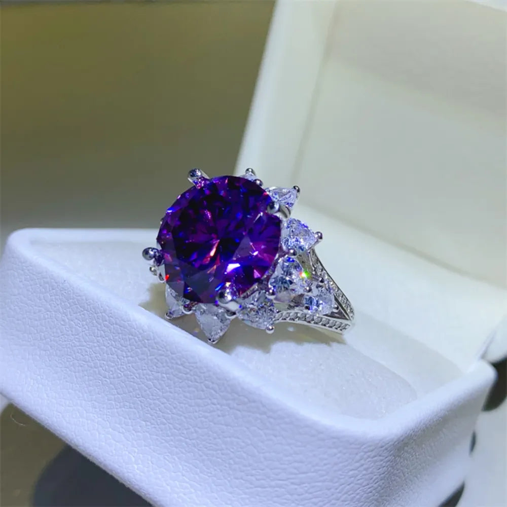 Deep purple sunburst moissanite cocktail ring with clear accent stones.