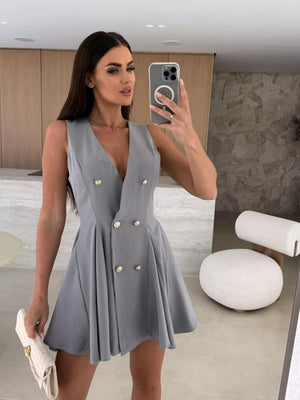 Gray double-breasted mini dress with V-neck, gold buttons, and pleated skirt.