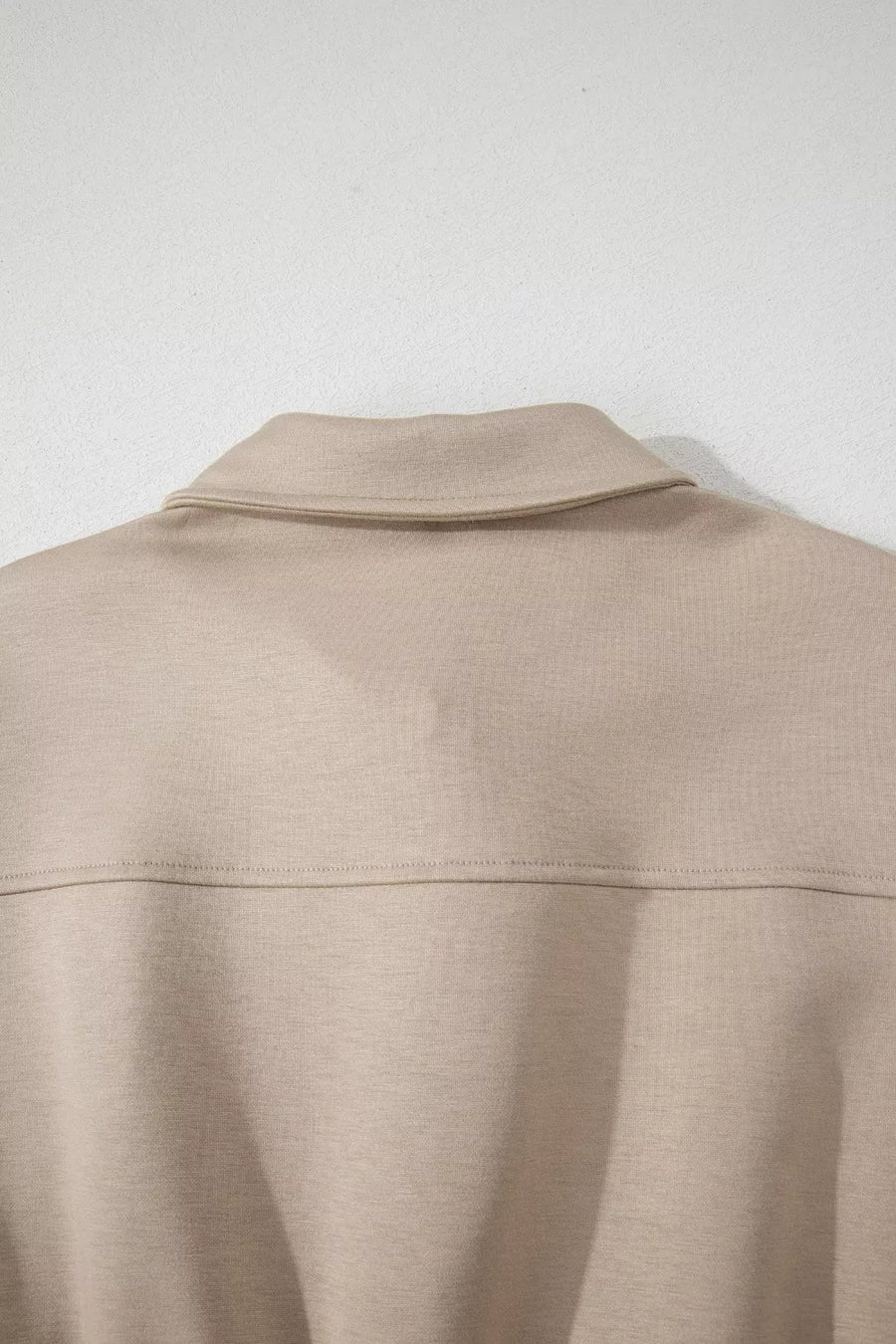 Chic collared zip front pocketed romper in beige.