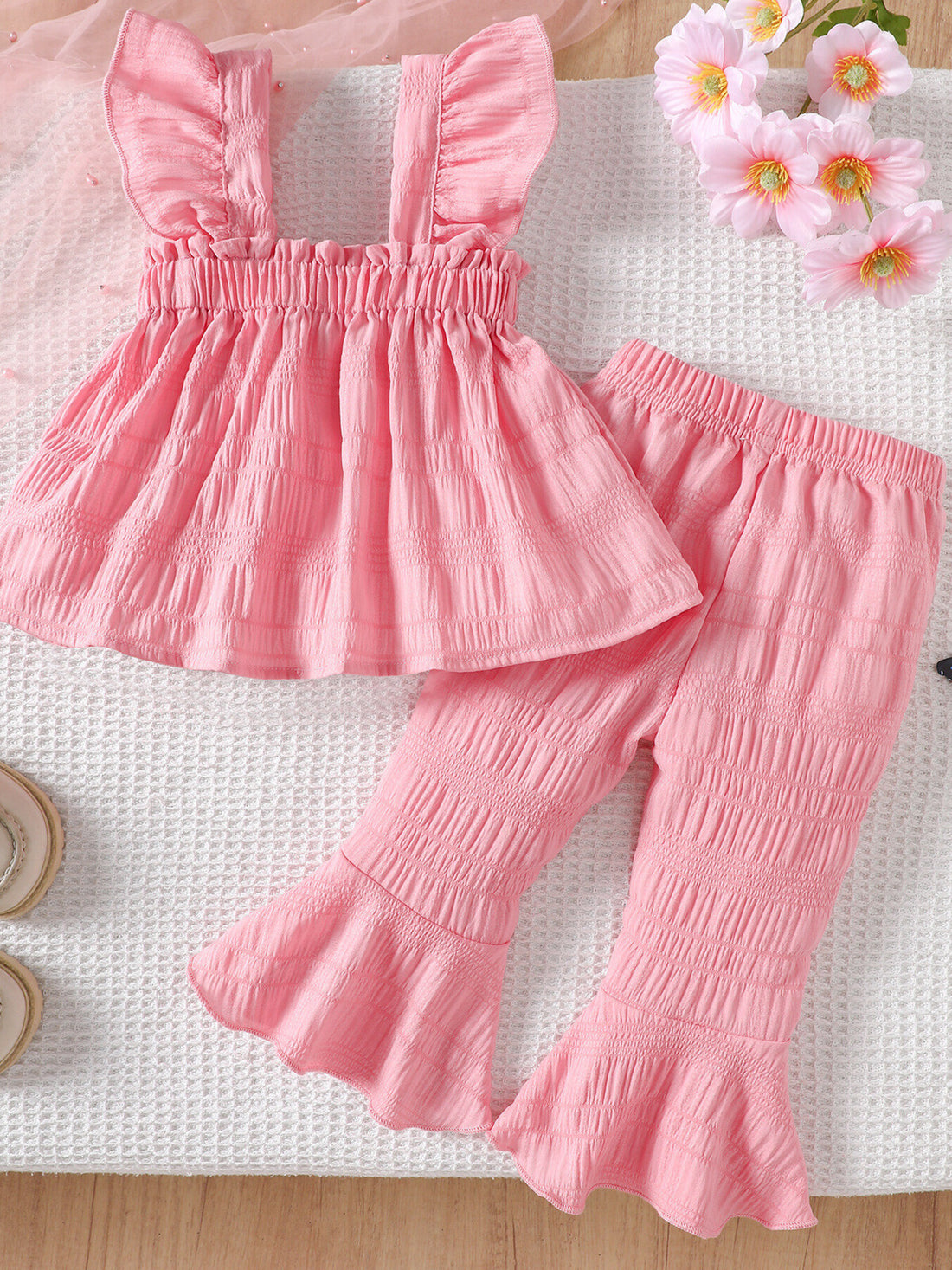 Pink ruffled baby top and pants set with textured fabric