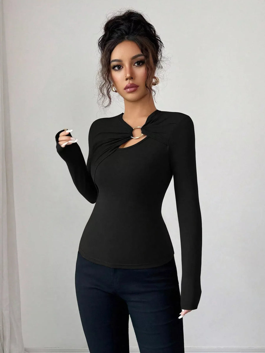 Black long-sleeve tee with asymmetrical cutout and gold ring detail