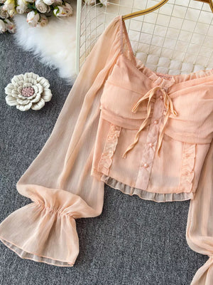 Peach chiffon maternity blouse with ruffled sleeves, bow tie, and button front.