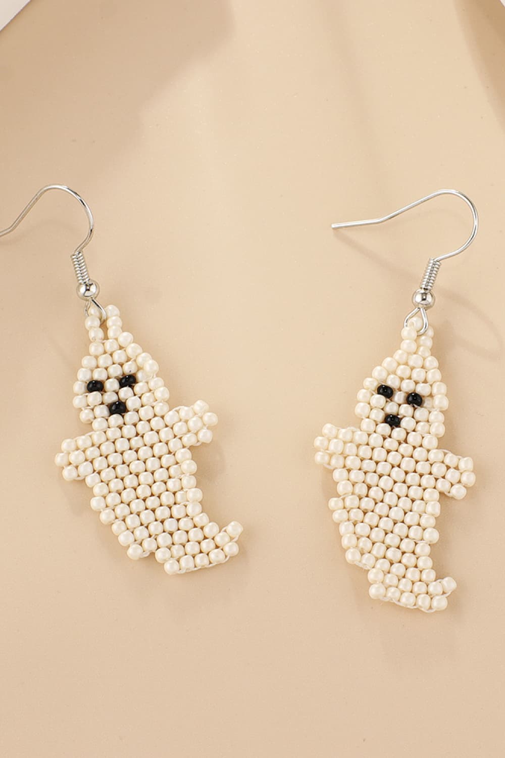 Ivory beaded ghost fringe earrings with black bead eyes