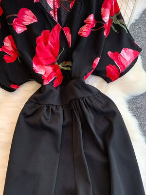 Black wide-leg romper with abstract red floral print top and ruched waist