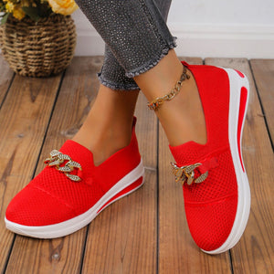 Red mesh slip-on flats with chunky chain detail and white soles.