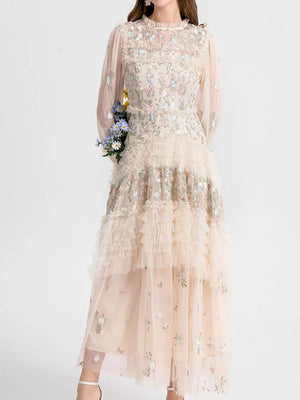 Embroidered floral tulle maxi gown with tiered ruffles and long sleeves.