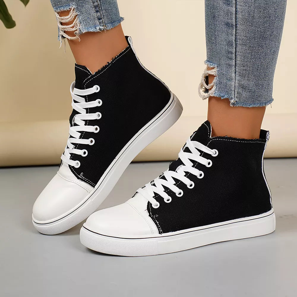 Black and white canvas high-top sneakers with white laces and toe caps.