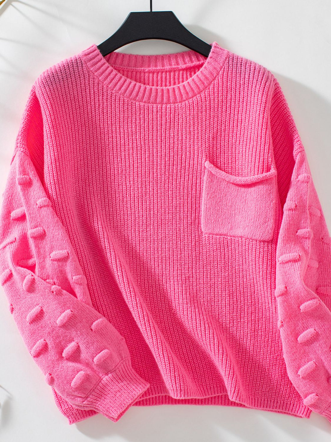Hot Pink knit sweater with textured sleeve details and a chest pocket.