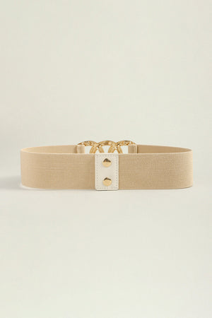 Tan elastic belt with gold triple ring buckle and white tab detail