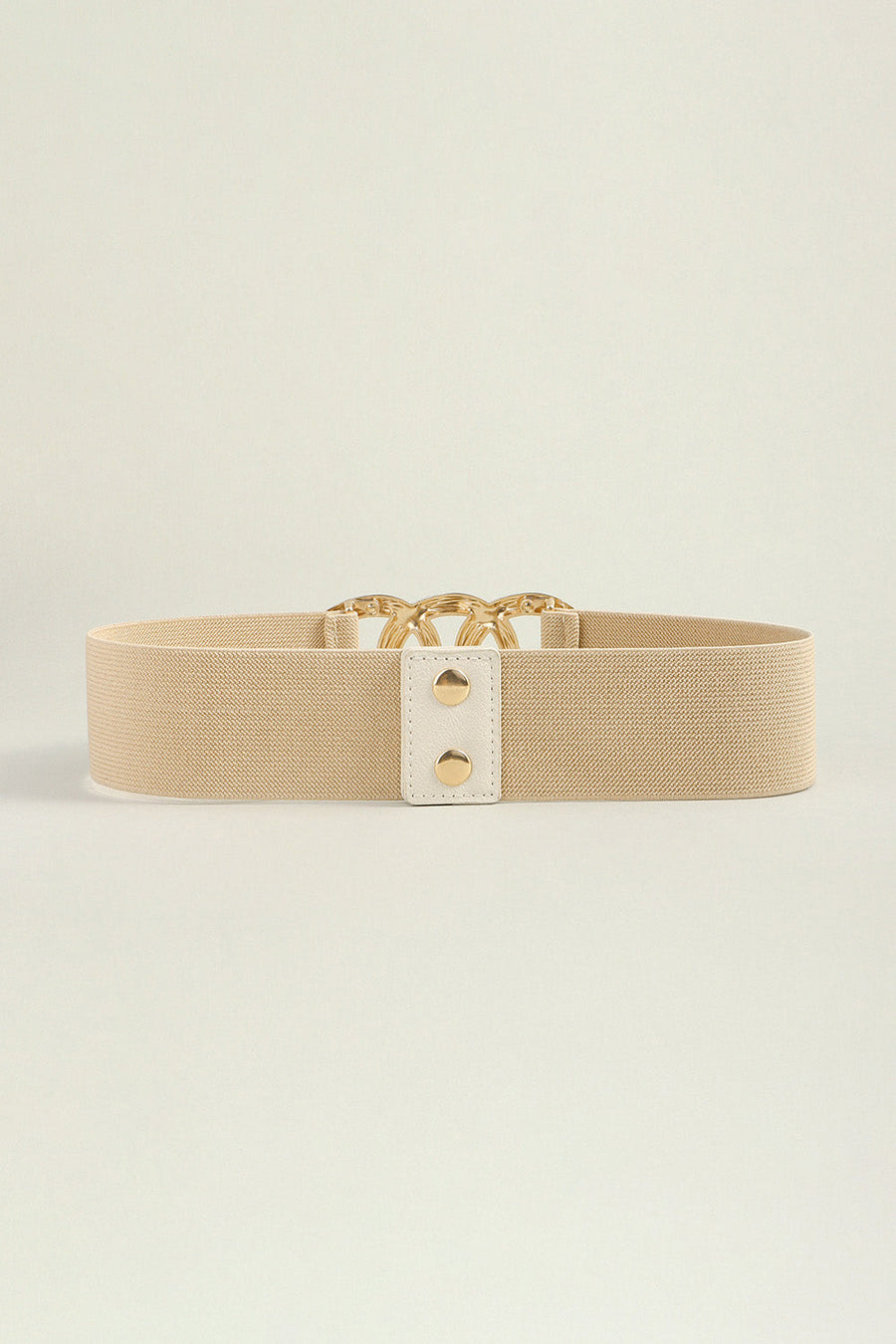 Tan elastic belt with gold triple ring buckle and white tab detail