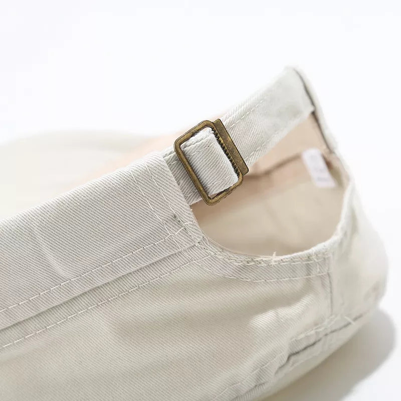 Beige cap with rivet details and N/A
