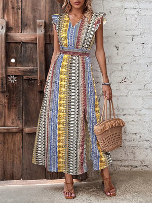 Bohemian maxi dress with ruffle sleeves, V-neck, smocked waist, and side slit in a colorful ethnic print.